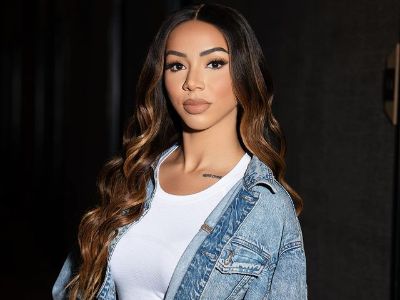 Brittany Renner is wearing a white top and a denim jacket in the picture.